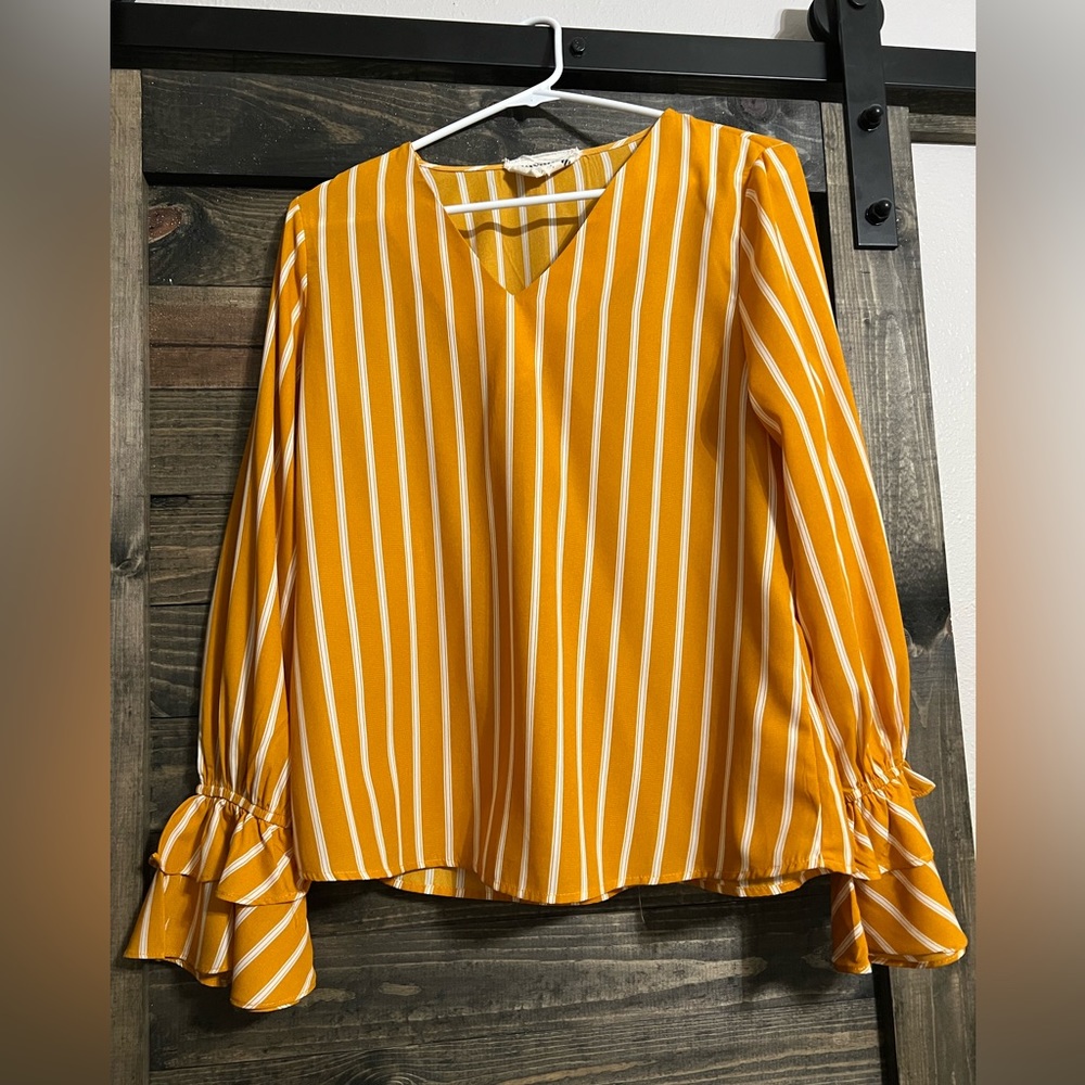 Mustard/gold striped top with bell sleeve detail. Worn once, cute with jeans!
